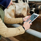 Close-up of young male worker of cowfarm with digital tablet - PhotoDune Item for Sale