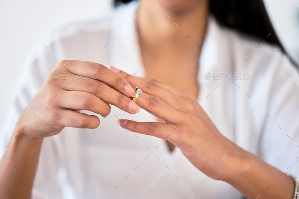 Woman hand taking off ring or jewelry for divorce and break engagement after fail marriage. Depress