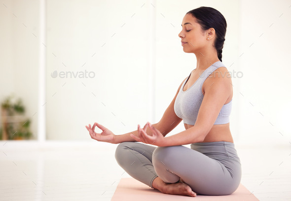Yoga, health and wellness woman doing lotus pose exercise and mediation inside a calming studio wit