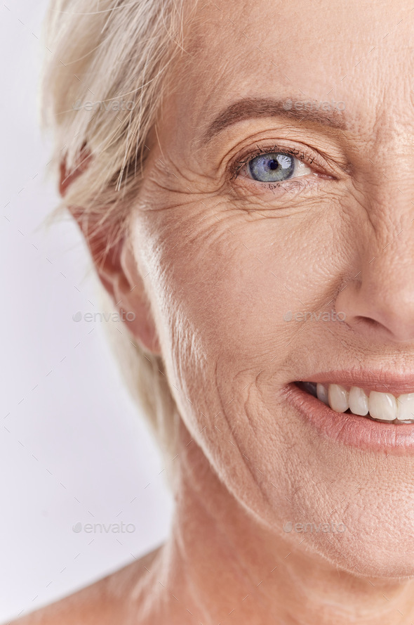 Closeup Portrait Of A Beautiful Older Woman Posing Against A Purple Background Healthy And 