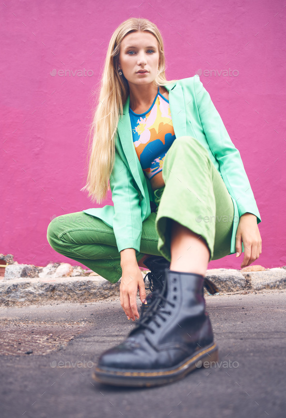 Fashion content creator and social media influencer in neon clothes and cool modern pose outdoors o