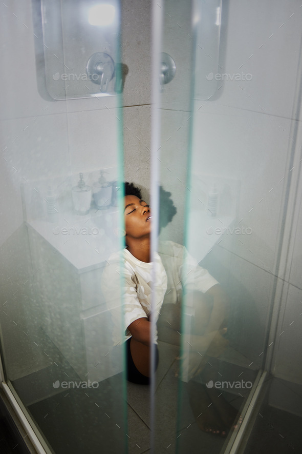Depression, anxiety and stress girl thinking in a shower at home. Black