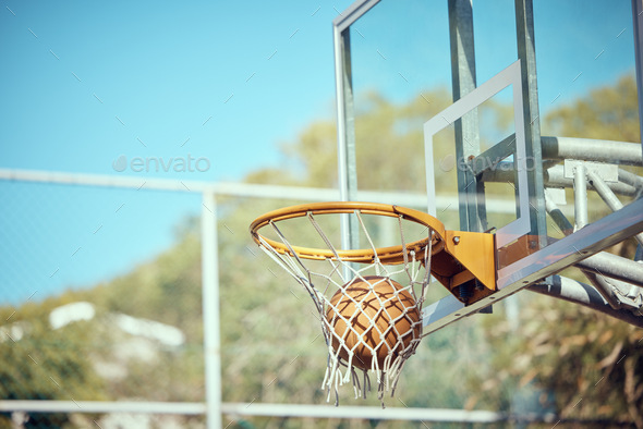 Basketball court, sport and hoop or ring net against a blue sky outside. Score and performance duri