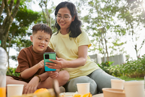 Mother Showing New App to Son - Stock Photo - Images