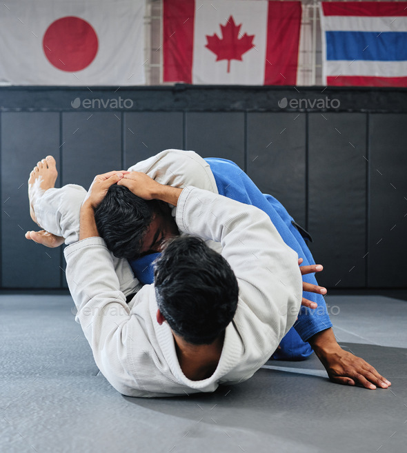 Male martial arts, fighting at a dojo and holding his opponent. Karate