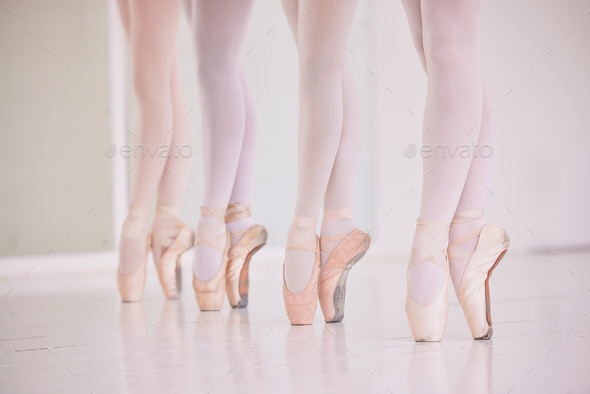 Many ballet feet, legs or tiptoe of elegant dancers dancing and practicing in a dance studio. Close