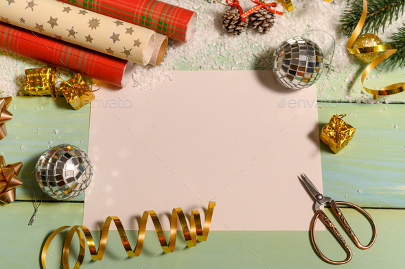 Christmas background with wrapping paper, scissors and Christmas  paraphernalia. Flat lay. Stock Photo by ja-aljona