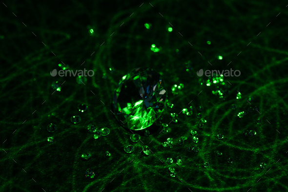 big and small diamonds with bright green neon light on dark background