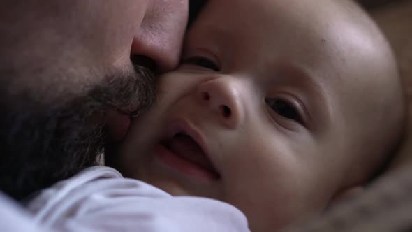 Cinematic Exstra Close Up Shot of Young Bearded Happy Neo Father is Playing Kiss with Newborn Baby