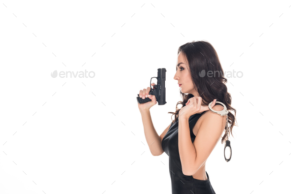 elegant security agent in black dress holding handgun and handcuffs, isolated on white