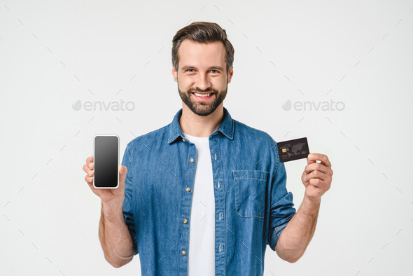 Happy caucasian young man holding smart phone with green mockup screen - Stock Photo - Images