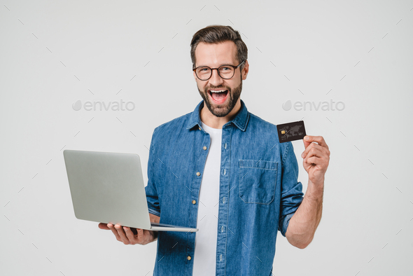 Happy as winner caucasian man freelancer student paying for online shopping - Stock Photo - Images