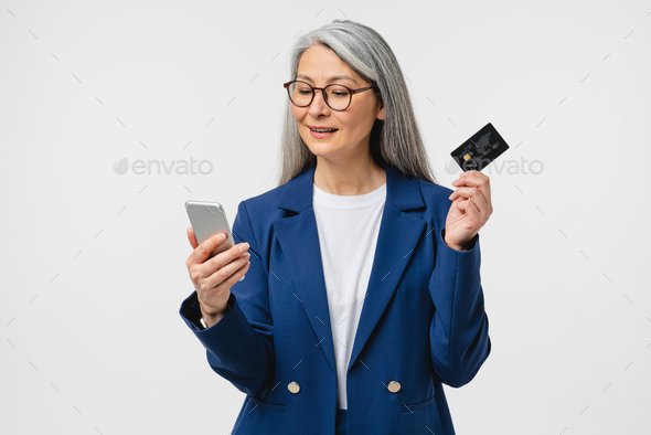 E-banking, e-commerce concept. Caucasian mature businesswoman  - Stock Photo - Images