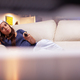 Woman adult resting on couch watching xmas movie on television - PhotoDune Item for Sale