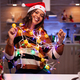 Young cheerful woman tangled in string lights - PhotoDune Item for Sale