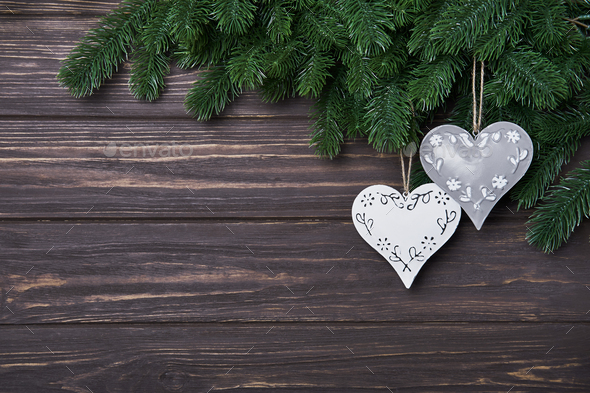 Christmas or New Year background with fir branches and tin hearts