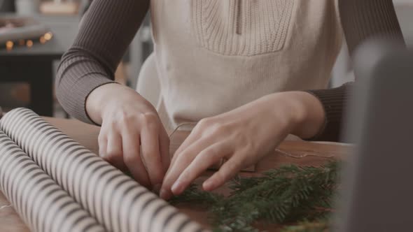 Tying Twine on Christmas Gift alt