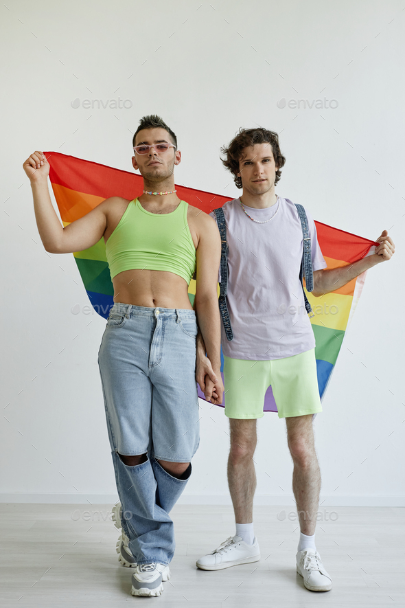 Two gay men posing with pride flag - Stock Photo - Images
