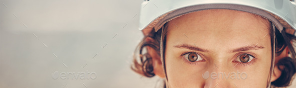 Portrait of a woman with helmet for hiking sport with a zoom in of eyes. Safety, secure and safety