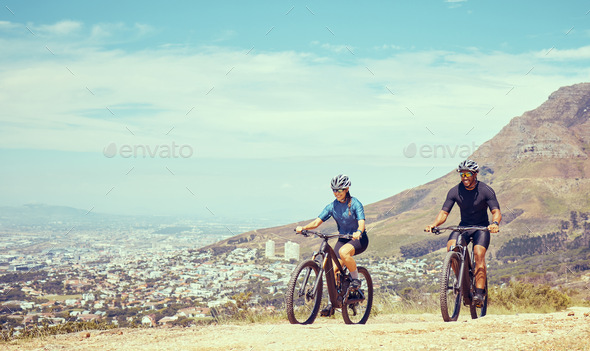 Fitness couple and cycling bicycle on a mountain hill or trail