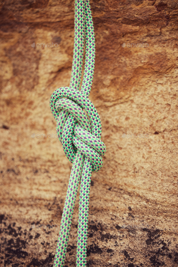 Safety, security and mountain climbing rope knot for helping on outdoor or  outside strong rock chal Stock Photo by YuriArcursPeopleimages