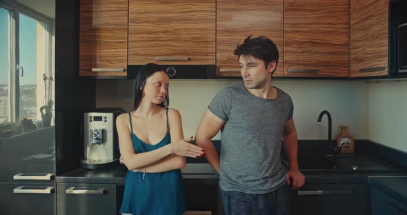 Young Couple in an Argument in a Kitchen. Make Peace Start Kissing.