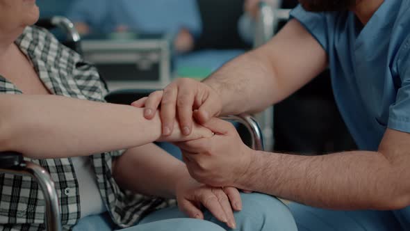 Close Up of Hands of Invalid Senior Woman and Man Nurse alt