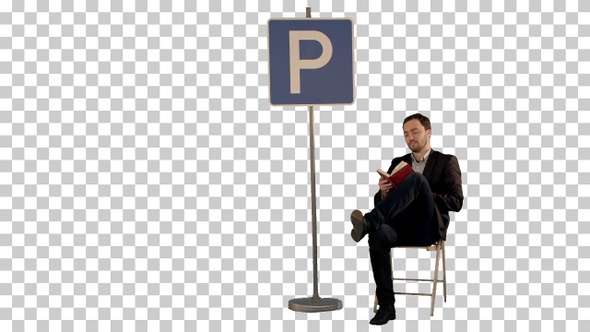 Businessman reading a book near parking sign, Alpha Channel