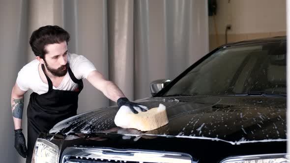 Man Washing His Car in a Garage alt