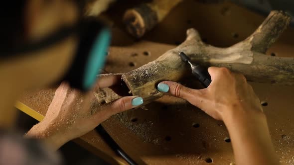 Female using power wood working tools graver, carving while crafting