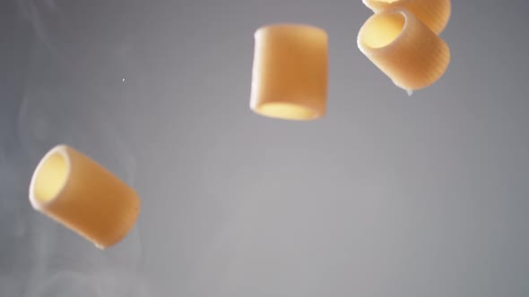 Camera follows cooking mezze maniche rigate pasta in tomato sauce. Slow Motion. alt