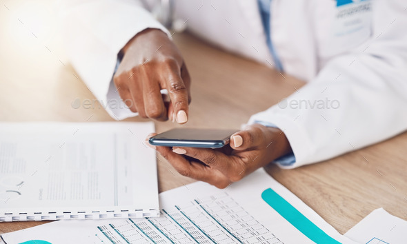 Above closeup african american woman doctor using her smart phone while working at a desk in her ho - Stock Photo - Images