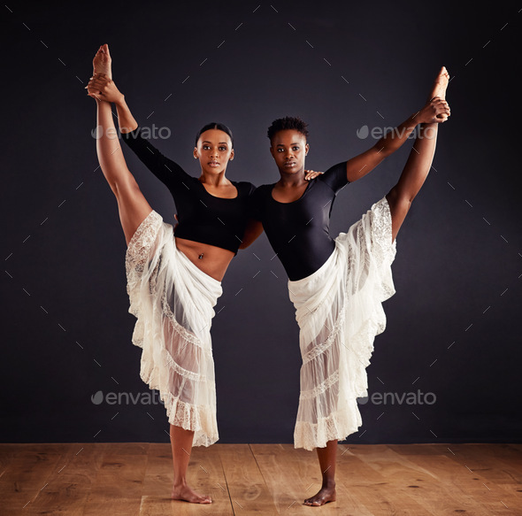 Two young female contemporary dancers using a soft white white skirt