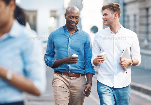 Men walk street with takeaway coffee while talk, smile and relax during lunch break. Black man outs