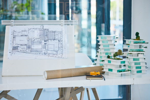 Architecture, blueprints and model building design in empty architectural company office. Vision en