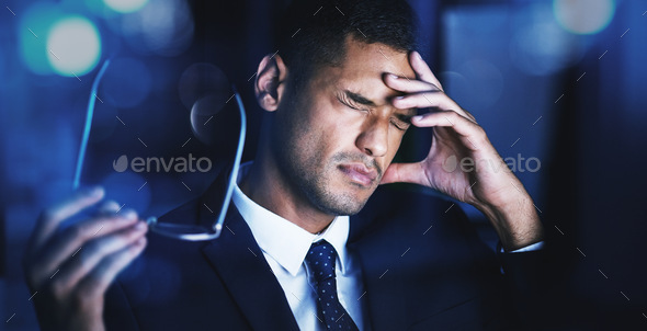 Eye strain, headache and office stress of a business man working at night on a tax audit. Financial