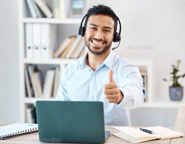 Thumbs up, customer service and call center with a man saying yes while working in telemarketing an