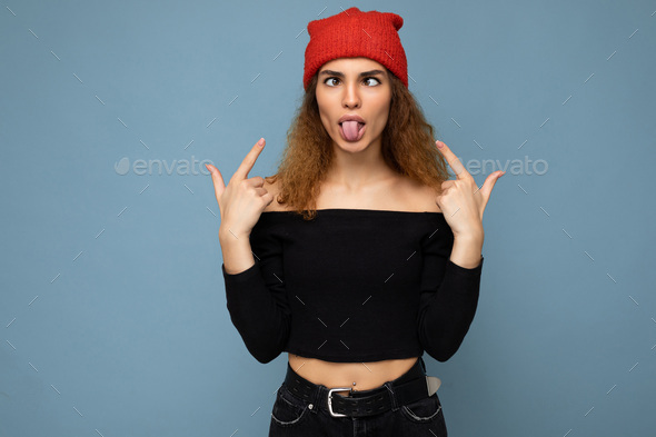 Photo of young positive beautiful brunette curly woman with sincere emotions wearing black crop top