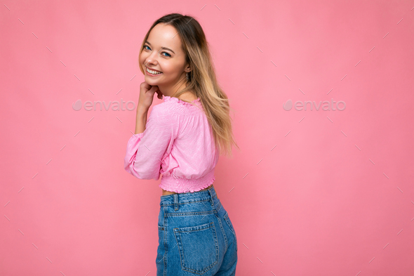 Portrait of young beautiful smiling hipster blonde woman in trendy pink crop top blouse. Sexy