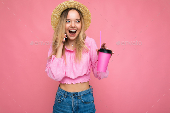 Photo of beautiful positive emotional young blonde woman wearing pink crop blouse and straw hat