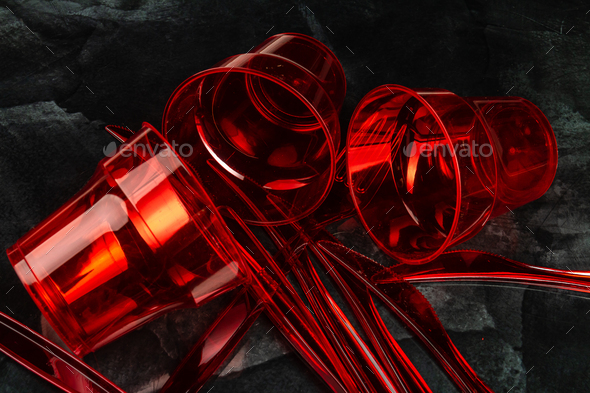 Close up red disposable empty plastic utensils. - Stock Photo - Images