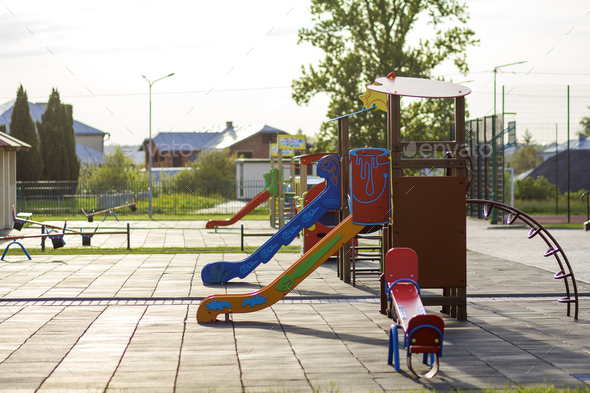 Beautiful playground in kindergarten with bright new alcove with red tile roof