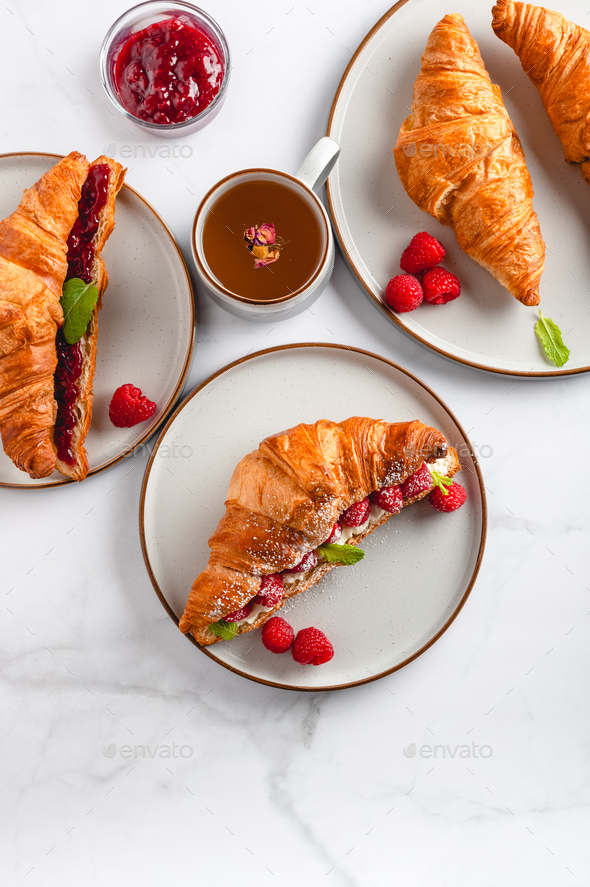 Croissant with fresh raspberries - Stock Photo - Images