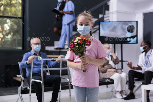 Portrait of little girl wearing medical protection face mask to prevent infection with covid19 - Stock Photo - Images