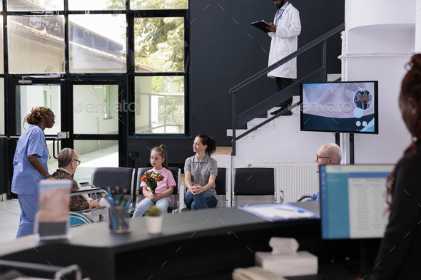 Physician assistant bringing senior patient to family after finishing medical consultation - Stock Photo - Images