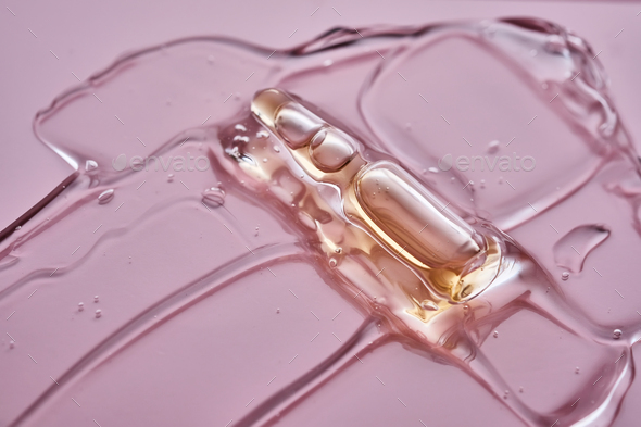 Ampoule of cosmetic product in a drop of gel. - Stock Photo - Images