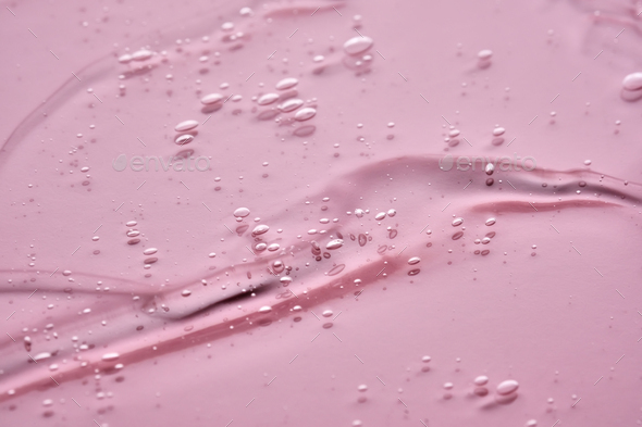 The texture of the cosmetic gel on a pink background. - Stock Photo - Images