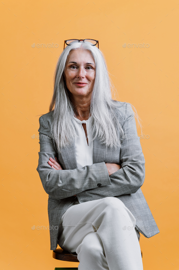 Beautiful senior woman posing on a corporate business photo session.