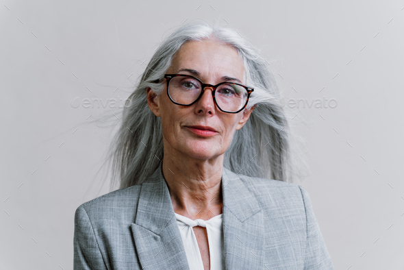 Beautiful senior woman posing on a corporate business photo session.