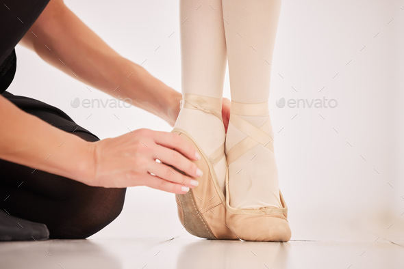 Ballet shoes, feet and learning from her dance coach or instructor about balance on tip toes in hal